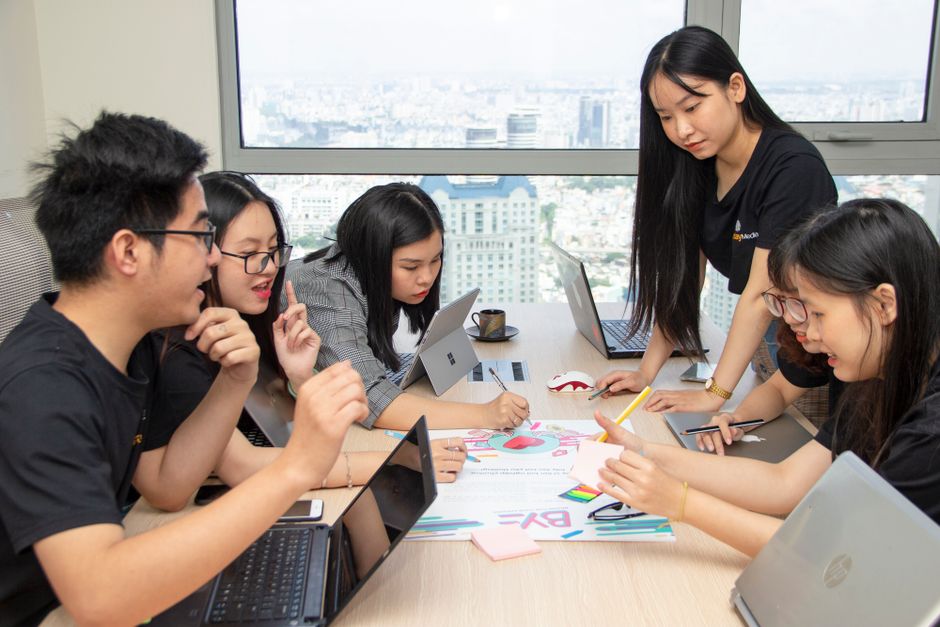 Team of young professionals collaborating creatively in a modern office space.