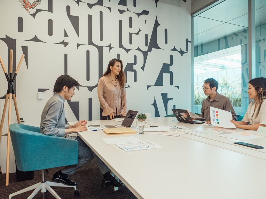 Diverse team engaged in brainstorming session in a modern office space.